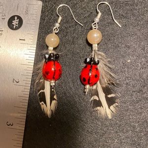 Glass ladybug, feather and beads handmade earrings